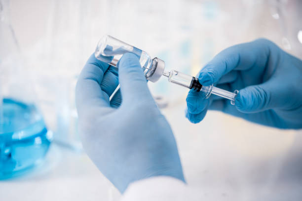 istock Hand of a scientist working in the laboratory. Vaccine development concept. 1280443379