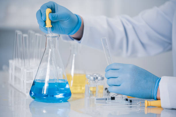 istock Hand of a scientist working in the laboratory. Vaccine development concept. 1280443426