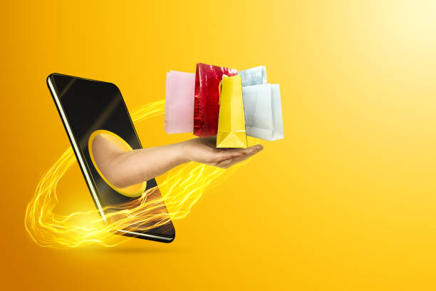 istock Hand delivers packages through smartphone screen on yellow background. Concept for online shopping, business, stay at home. 1280443501