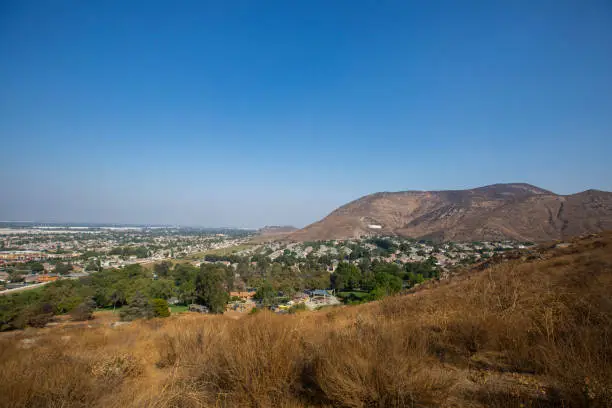 View of a neighborhood nestled in the mountains of Fontana, California, USA.