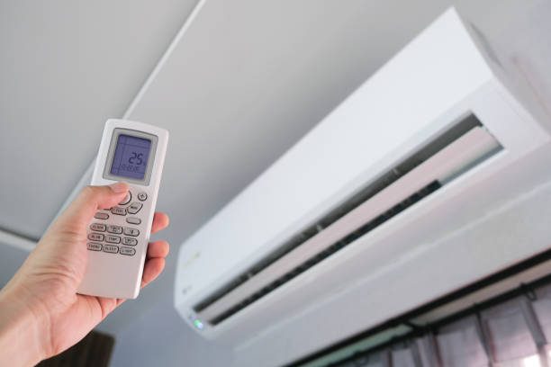 istock Man's hand using remote control open The air conditioner is cooled to 25 degrees Celsius in his bedroom. Health concepts and energy savings 1280446970