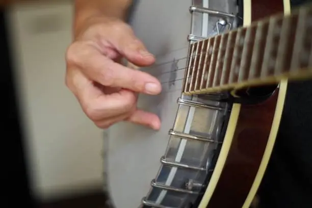 Photo of Close up of hands playing the banjo