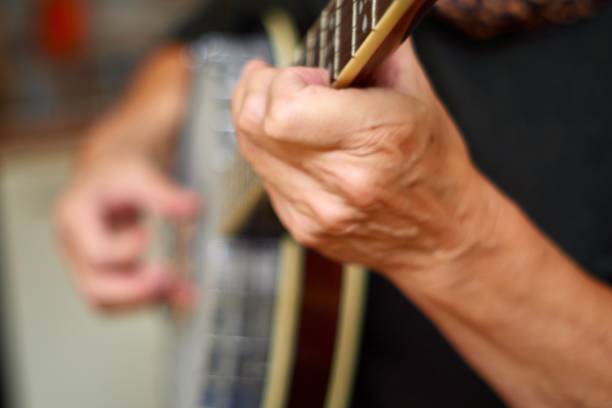 Banjo is standing in front of a raw brick wall in the rehearsal garage of a band, music concept, copy space, selected focus