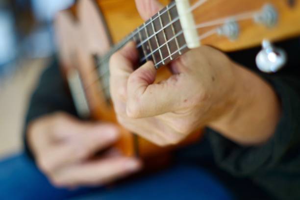 istock Close up of hands playing the ukulele 1280451189