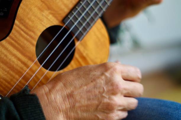 istock Close up of hands playing the ukulele 1280451211