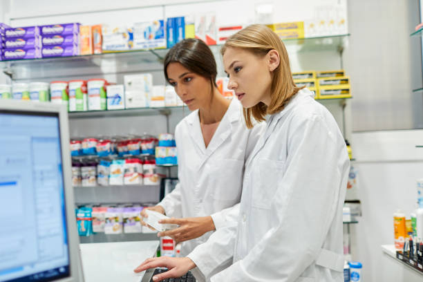 istock A pharmacy cashier and owner looking at a computer screen. 1280451293