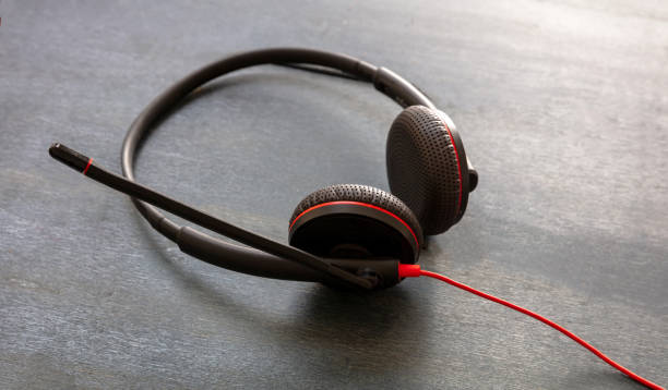 istock Headset on black background. Call center, home office, customer service support, help desk 1280453434