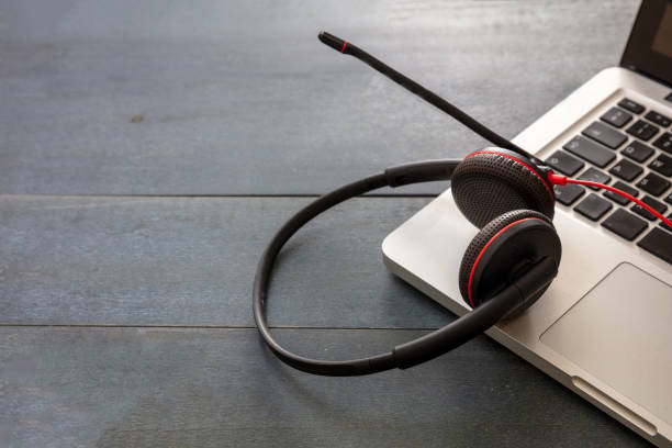 istock Headset on black background. Call center, home office, customer service support, help desk 1280453435