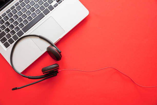 istock Headset on black background. Call center, home office, customer service support, help desk 1280453445