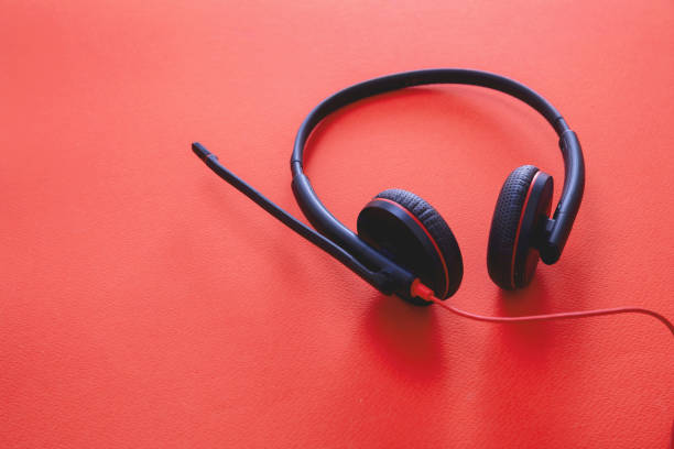 istock Headset on black background. Call center, home office, customer service support, help desk 1280453447
