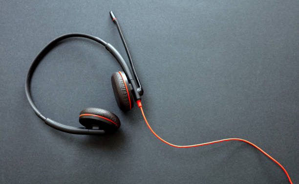 istock Headset on black background. Call center, home office, customer service support, help desk 1280453449