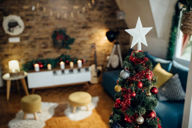 istock White star shape on top of Christmas tree at home. 1280454059