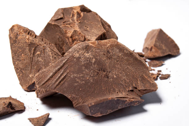 Cacao paste or mass (Theobroma cacao). Broken chocolate pieces ingredients for making chocolate. stock photo