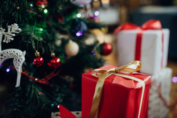 istock Close-up of red Christmas present under the tree. 1280454797