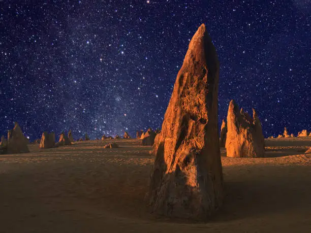 Stars over the landscape of the Pinnacle desert limestone formations at night near Cervantes in Western Australia.