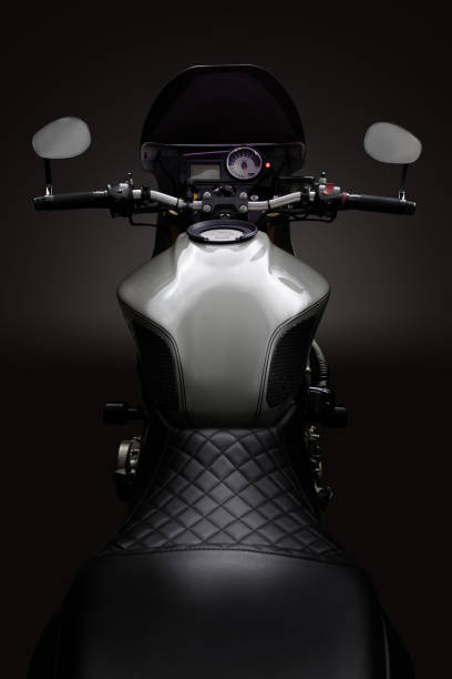 istock Custom caferacer motorbike on dark background with its headlight on. 1280454870