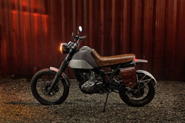 istock Custom scrambler motorbike on a rusty container background. 1280454940