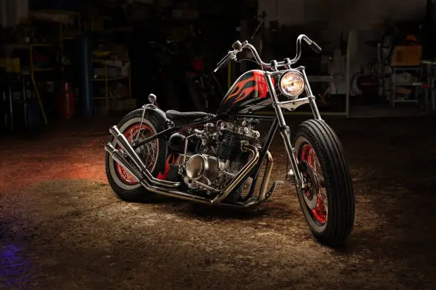 Custom bobber motorbike. Vintage style motorcycle in an workshop garage.