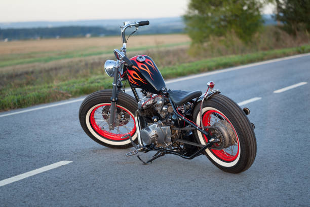 istock Custom bobber motorbike standing on a road. 1280455133