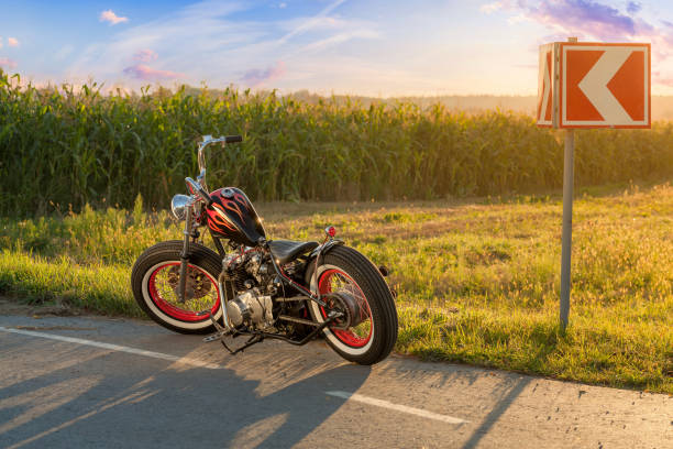 istock Custom bobber motorbike standing on a road. 1280455688