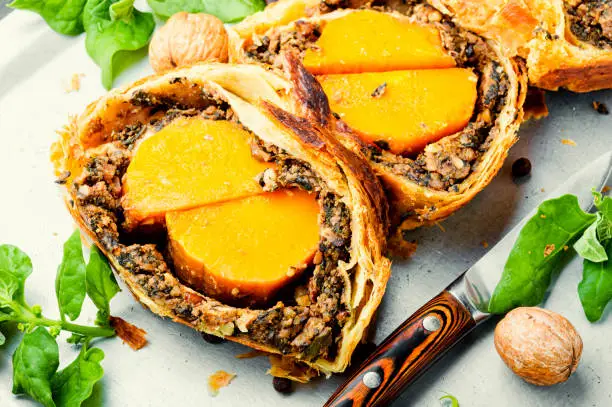 Loaf with baked pumpkin and mushrooms.Wellington pumpkin, autumn traditional food.