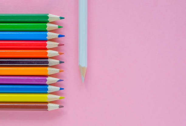 istock Several multi-colored pencils are laid out on a pink background 1280458321