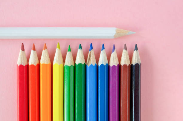 istock Several multi-colored pencils are laid out on a pink background. 1280458375