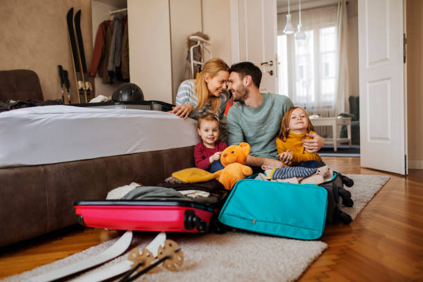 Perfect family portrait Shot of a happy family packing their bags for a winter vacation Budget Hotel stock pictures, royalty-free photos & images