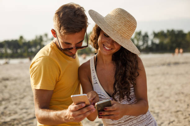 istock Couple watching their photos on a smart phone 1280459308