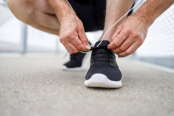 istock Tying shoe laces on running sneakers 1280462349