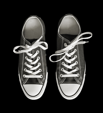 Pair of generic sneakers isolated on black background