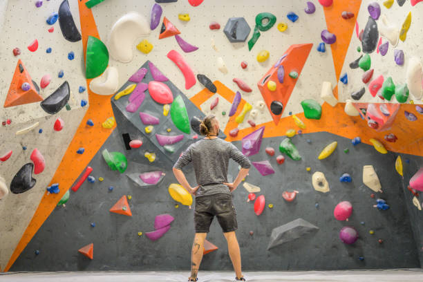 istock Man standing in indoor climbing gym 1280463114