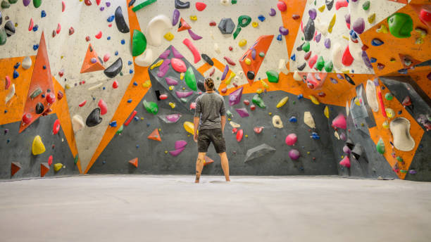 istock Man standing in indoor climbing gym 1280463255