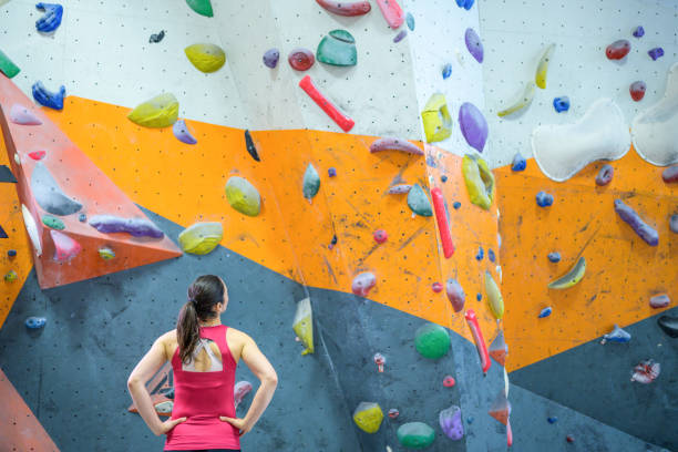 istock Woman standing in indoor climbing gym 1280463341