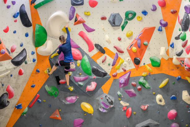 istock Woman climbing colourful wall 1280463420