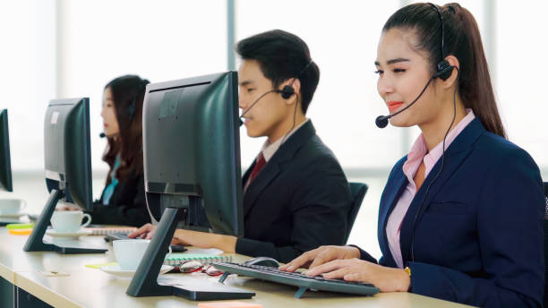 istock Business people wearing headset working in office 1280463484