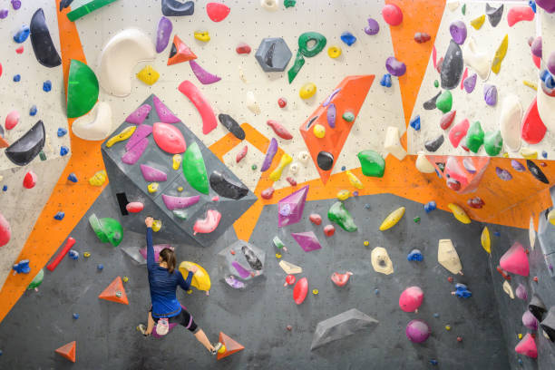 istock Woman climbing colourful wall 1280463553