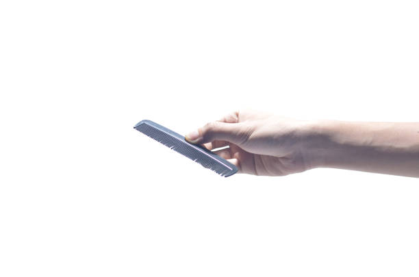 istock hand holding comb brush,isolated on white background 1280463622