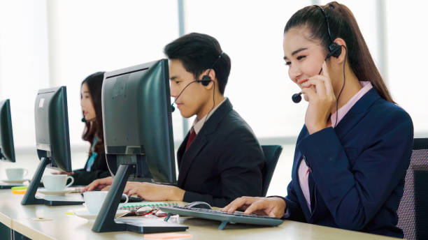 istock Business people wearing headset working in office 1280463675