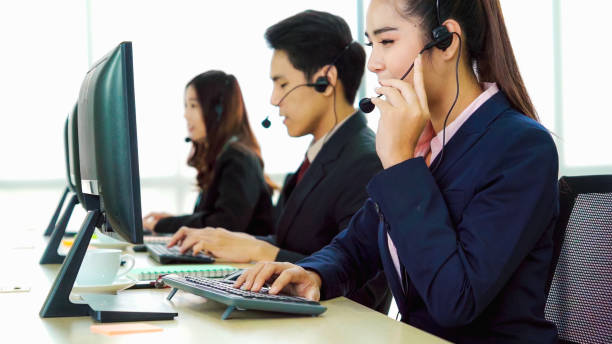 istock Business people wearing headset working in office 1280464893