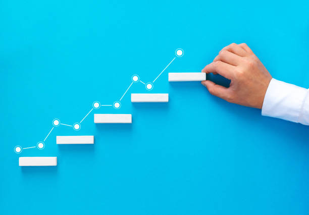 istock Businessman hand arranging wood block stacking as step stair with growing arrow graph. Business development to success, profit and investment. 1280466243