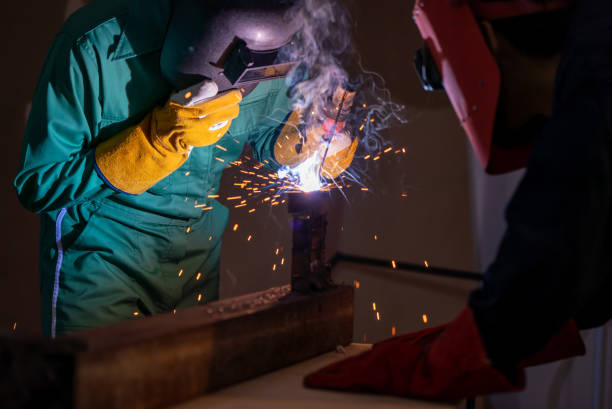 istock Metal welding steel works using electric arc welding machine 1280466843