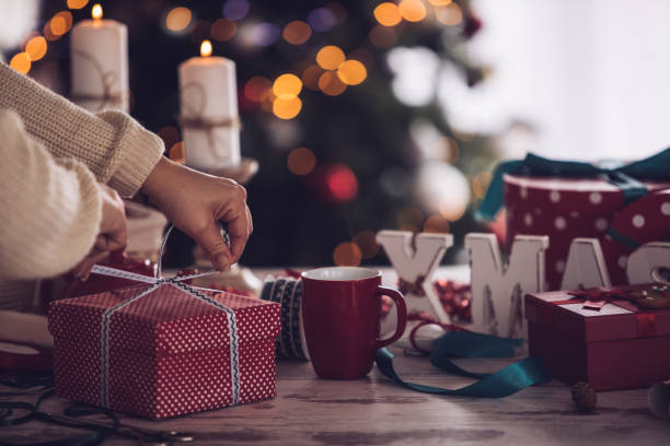 istock Tying a ribbon in a bow on a Christmas present 1280466923