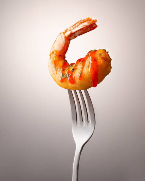 fried shrimp on fork minimal photography