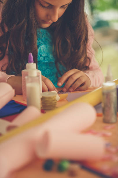 istock Young girl enjoying while doing arts and crafts 1280467319