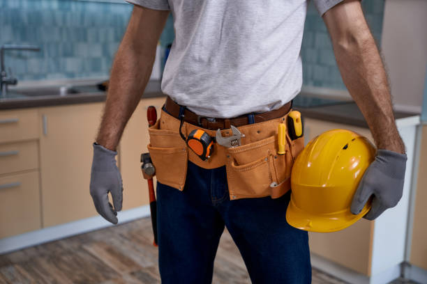 istock Worker with instrument belt and helmet standing in kitchen 1280468206