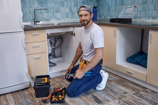 istock Young caucasian male worker on floor next to kitchen sink 1280468215