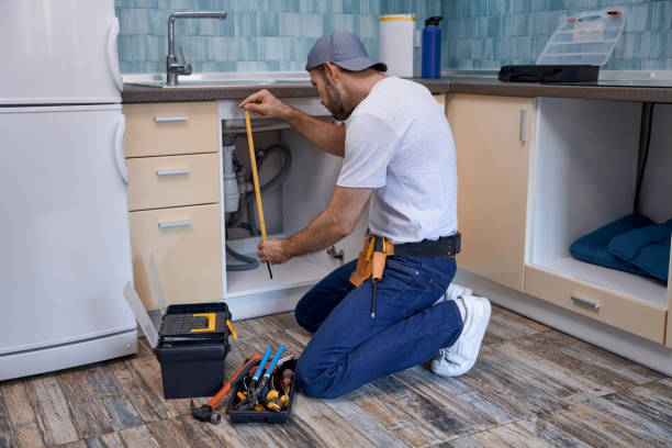 istock Young caucasian repairman measuring kitchen drawer under sink 1280468225