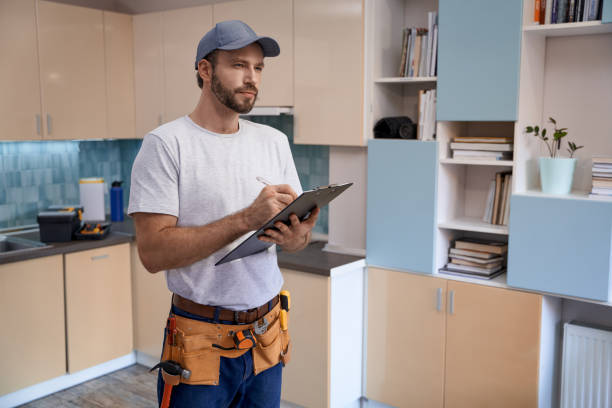 istock Young caucasian repairman writing in notebook 1280468235