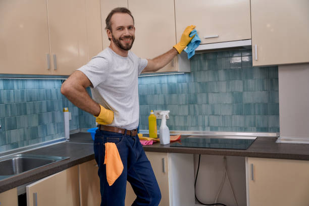 istock Young caucasian man smiling while cleaning kitchen furniture 1280468246
